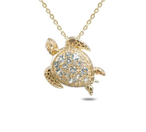 The picture shows a 14K yellow gold leatherback sea turtle pendant with aquamarine gemstones.