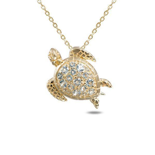 The picture shows a 14K yellow gold leatherback sea turtle pendant with aquamarine gemstones.