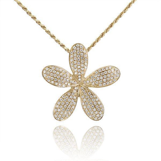 In this photo there is a large yellow gold plumeria pendant with diamonds. 