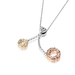 The picture shows a 14K rose and yellow gold two circles and one heart charm pendant with hand engravings.