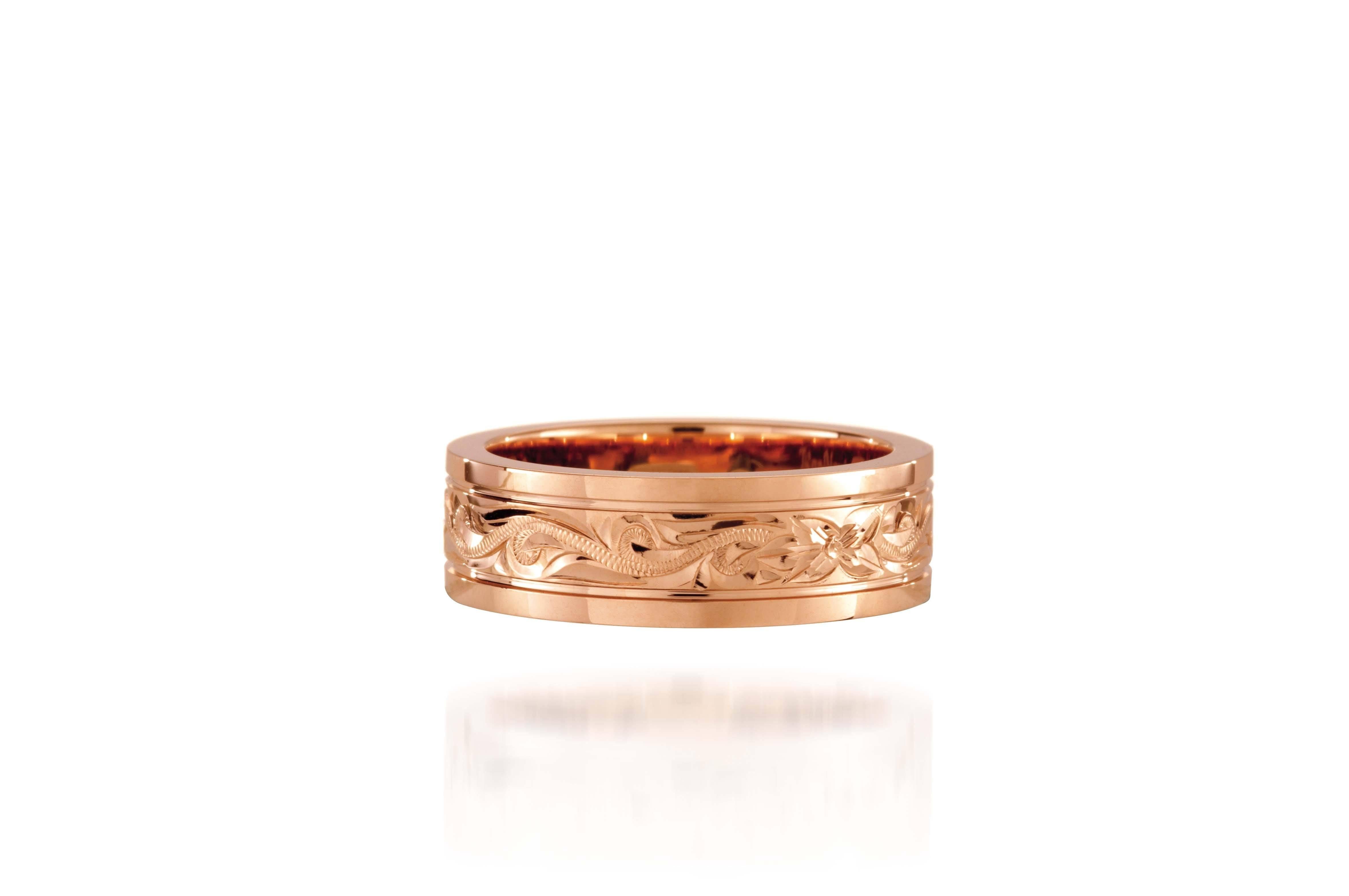 In this photo there is a rose gold ring with flower and scroll hand-engravings.