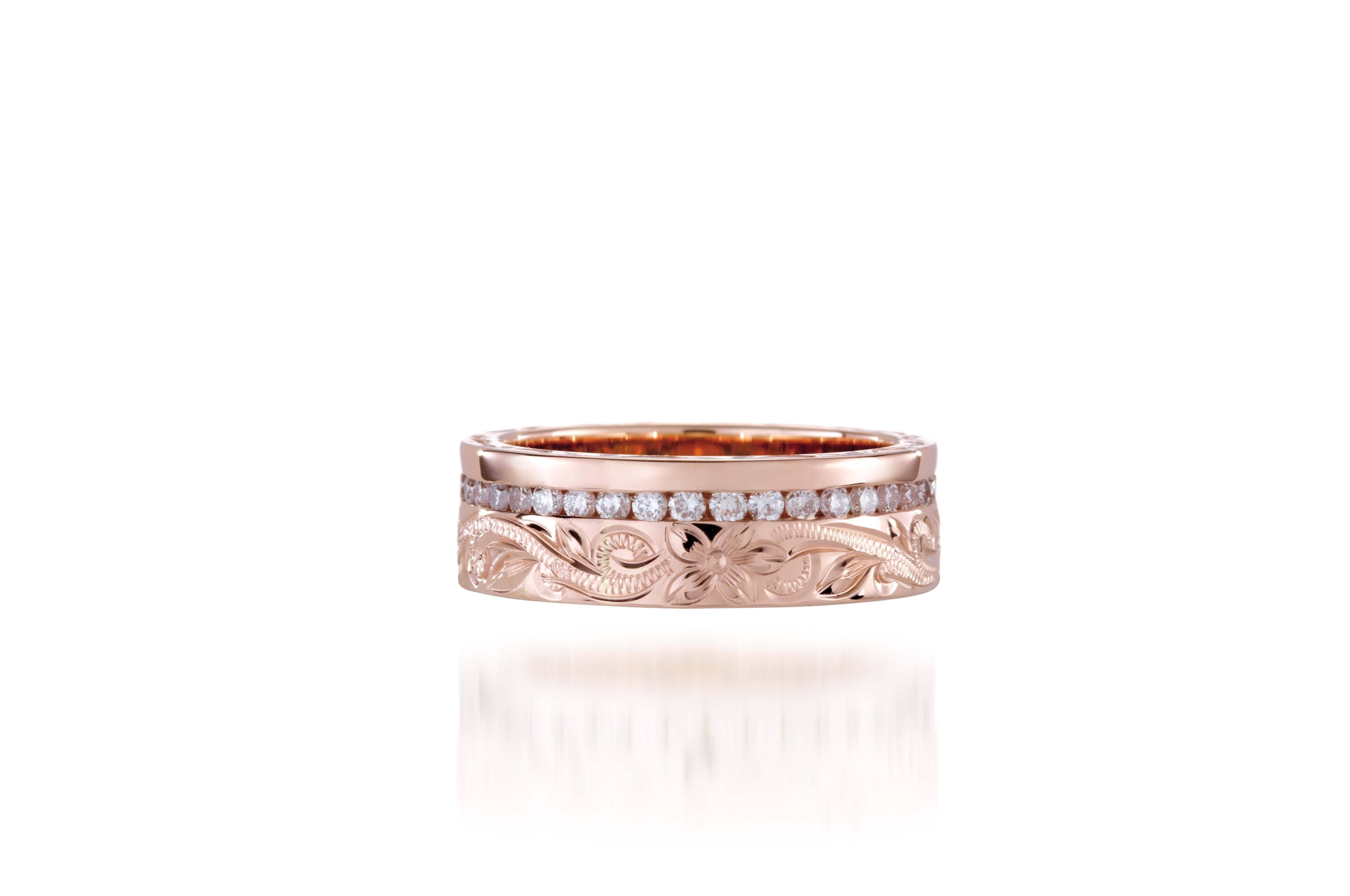 In this photo there is a rose gold ring with diamonds and hand engravings that include a flower and scroll.
