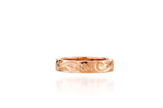 In this photo there is a rose gold ring with flower and scroll hand engravings.