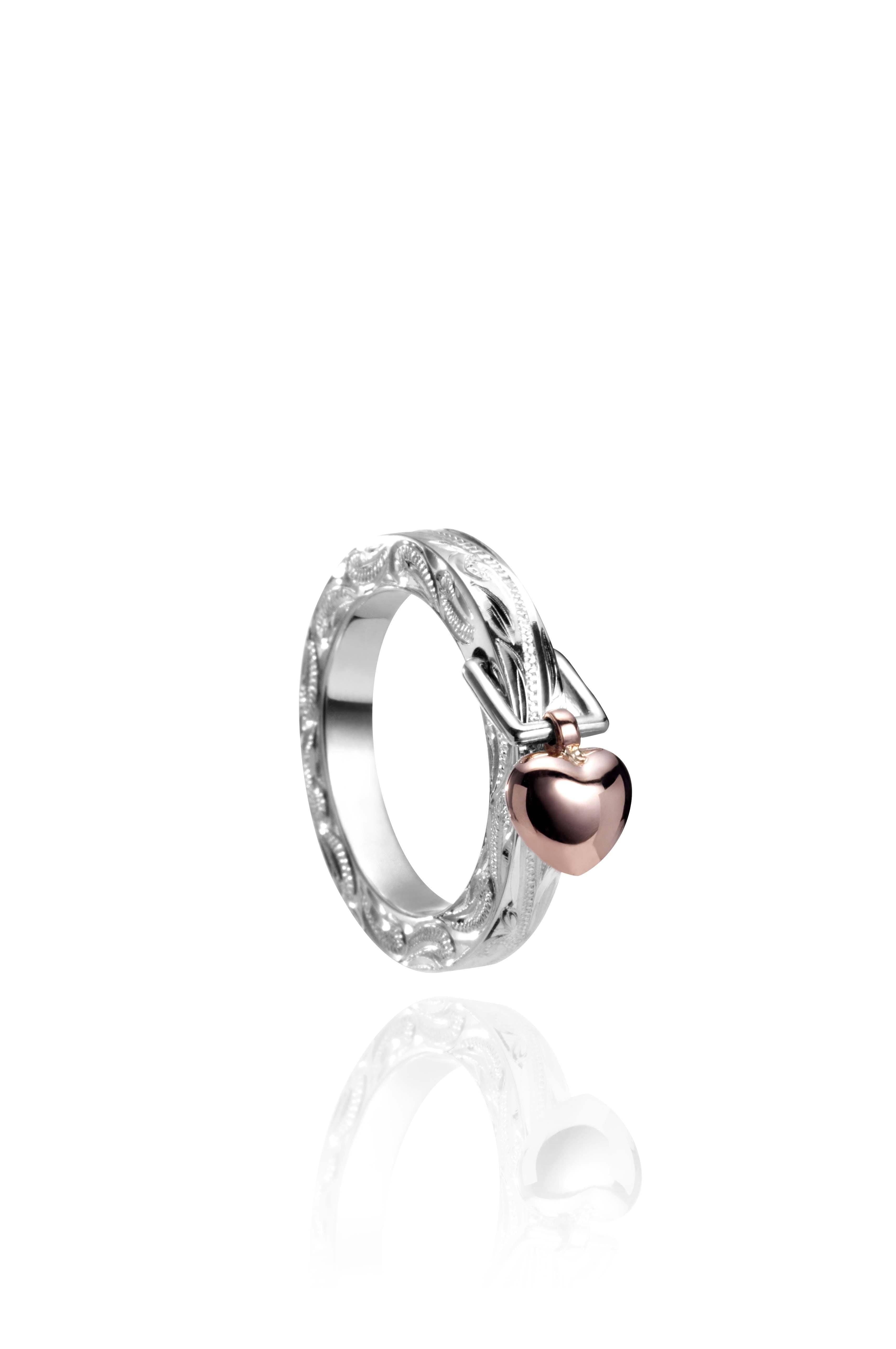 The picture shows a 14K rose gold and 925 sterling silver heart ring with hand engravings.