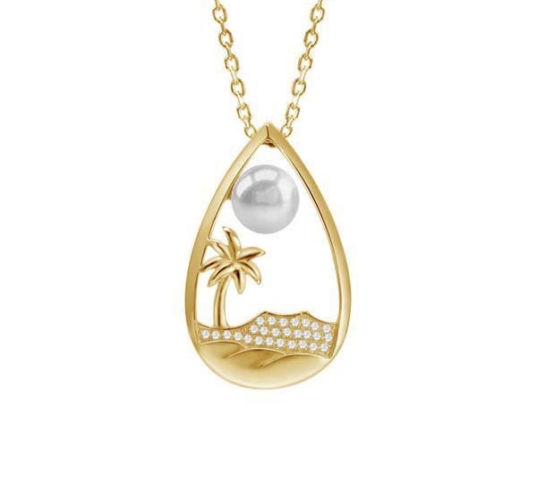 In this photo there is a yellow gold tear drop pendant with a palm tree, Diamond Head mountain view, ocean waves, diamonds, and one white Akoya pearl.