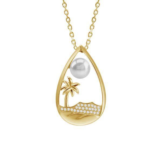 In this photo there is a yellow gold tear drop pendant with a palm tree, Diamond Head mountain view, ocean waves, diamonds, and one white Akoya pearl.