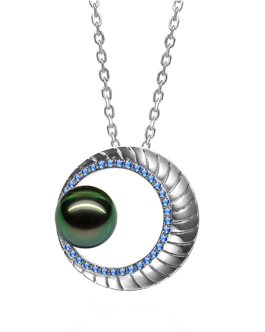 In this photo there is a white gold moon pendant with sapphires and a dark green pearl.