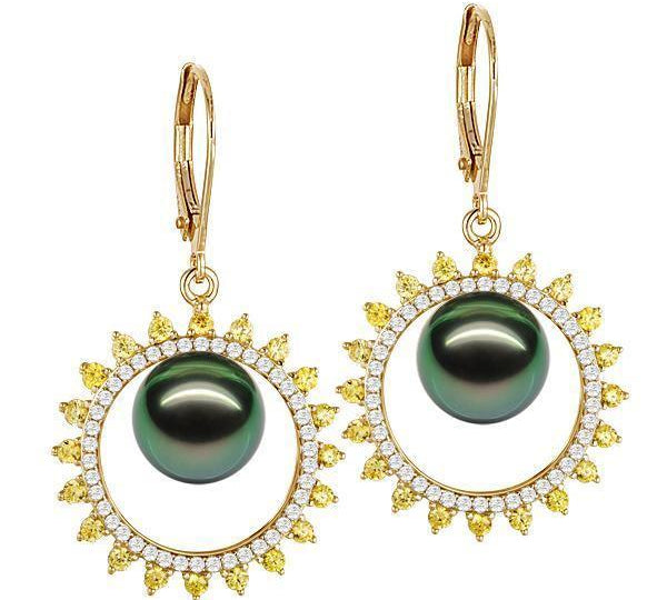 In this photo there is a pair of yellow gold sun earrings, with yellow and white diamonds and dark green pearls.