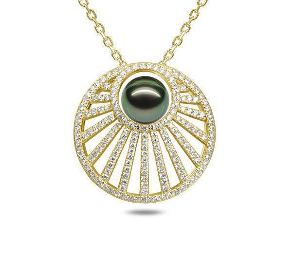 In this photo there is a yellow gold sun rays pendant with one dark green pearl and lined with diamonds.