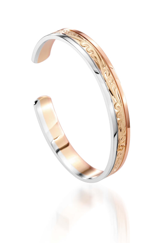 The picture shows a 14K white, yellow, and rose gold tri-color bangle with scroll engraving.