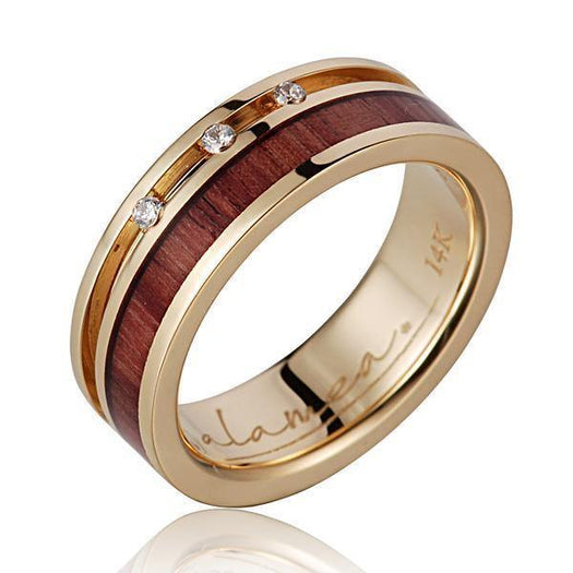 In this photo there is a 14K yellow gold and tulip poplar wood ring with three diamonds.