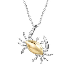The picture shows a 14K two-tone (yellow and white gold) blue crab pendant with eye diamonds.