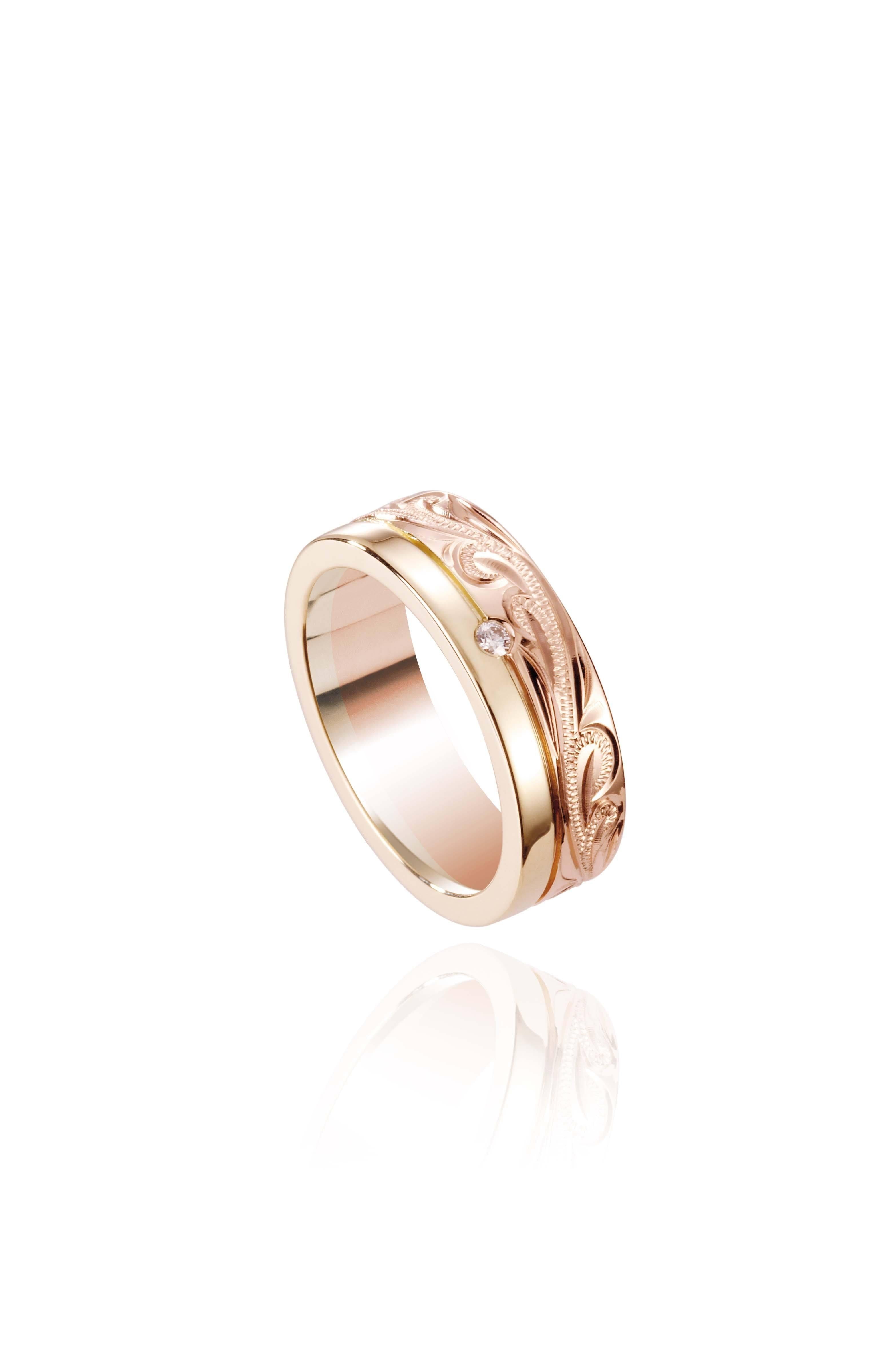 The picture shows a 14K yellow and rose gold two-tone pinched channel 6mm ring with a diamond, and hand-engravings.