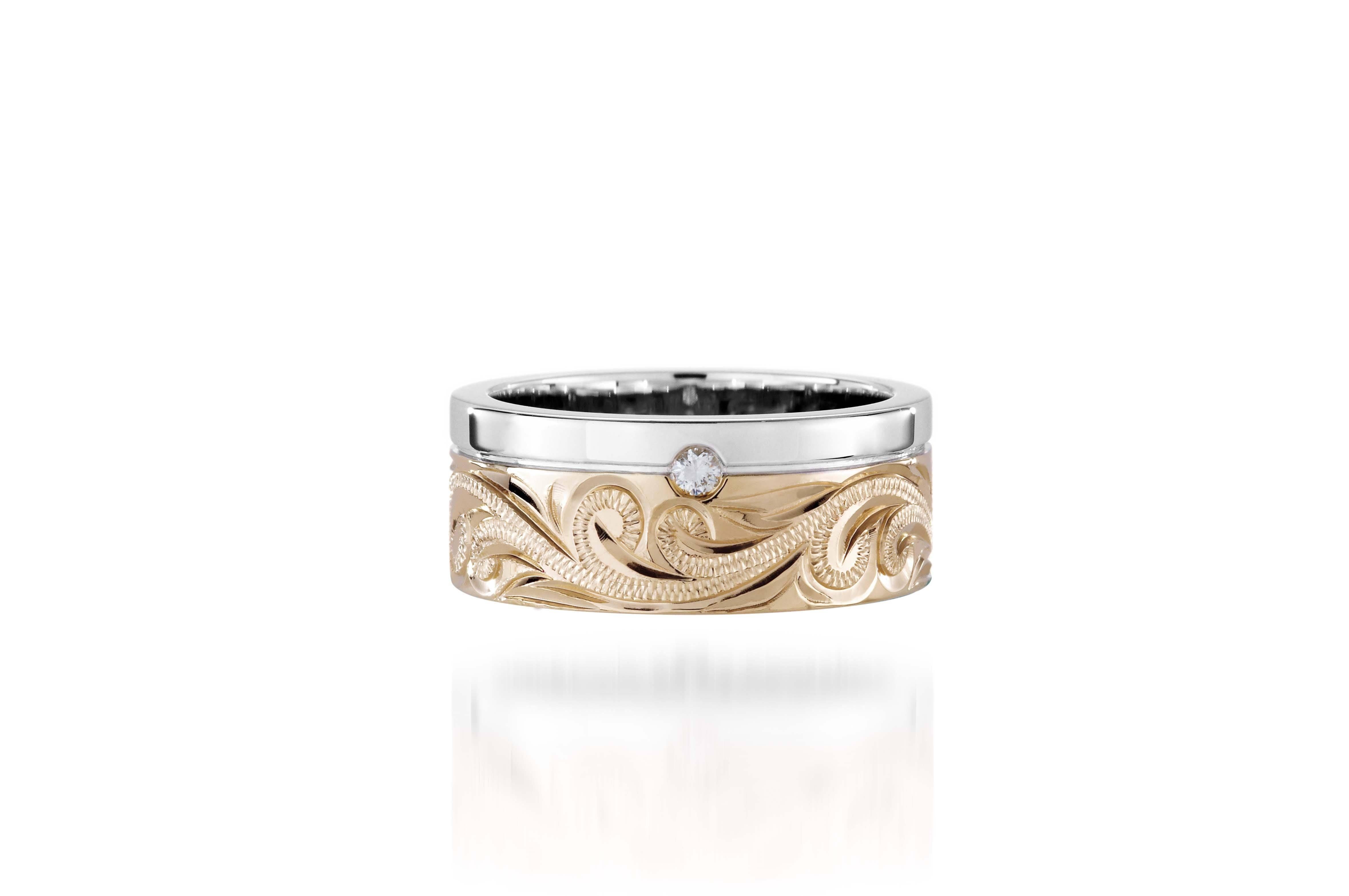 The picture shows a 14K white and yellow gold two-tone 8 mm channel ring with a diamond and hand-engravings.