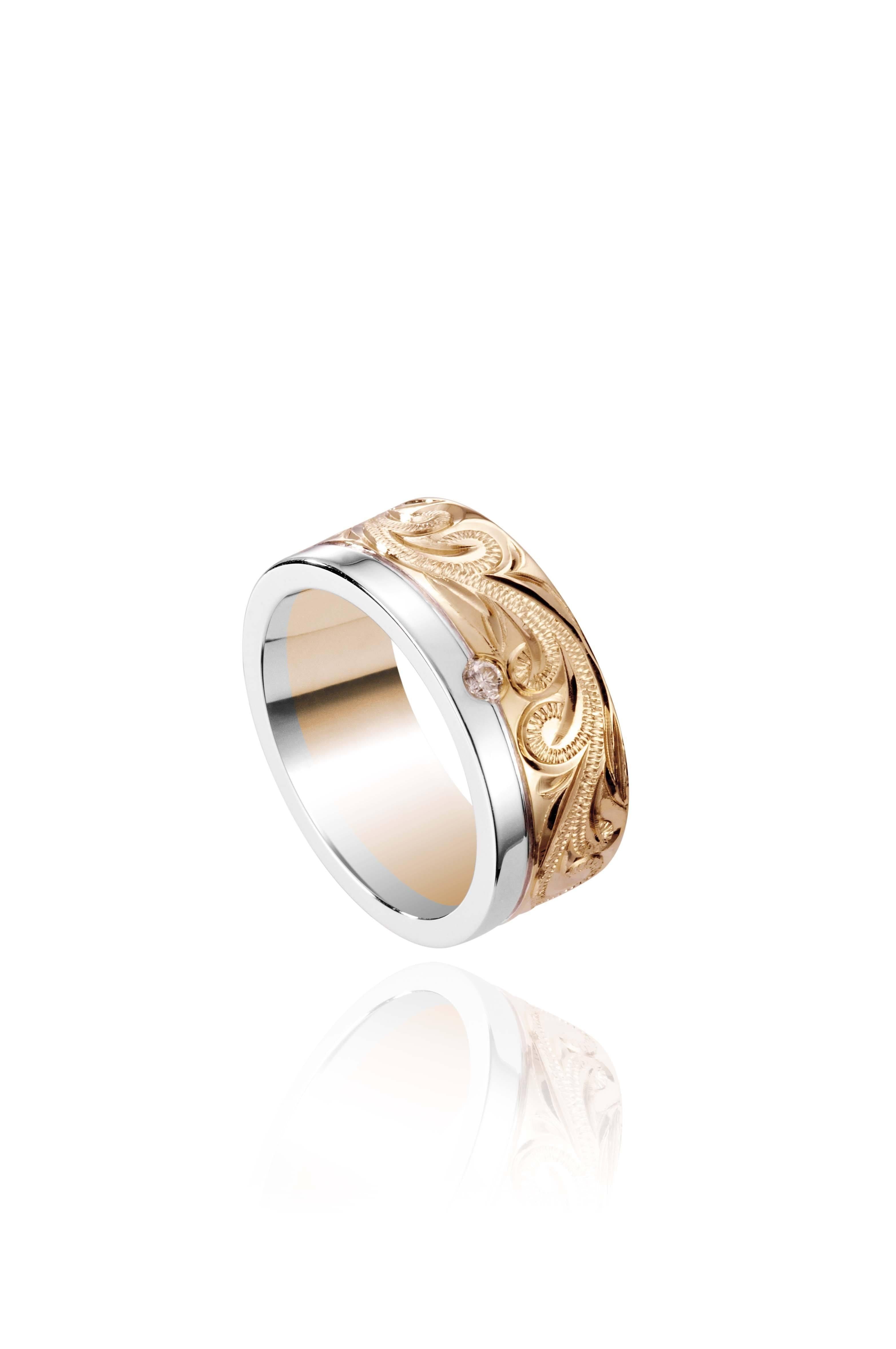 The picture shows a 14K white and yellow gold two-tone 8 mm channel ring with a diamond and hand-engravings.