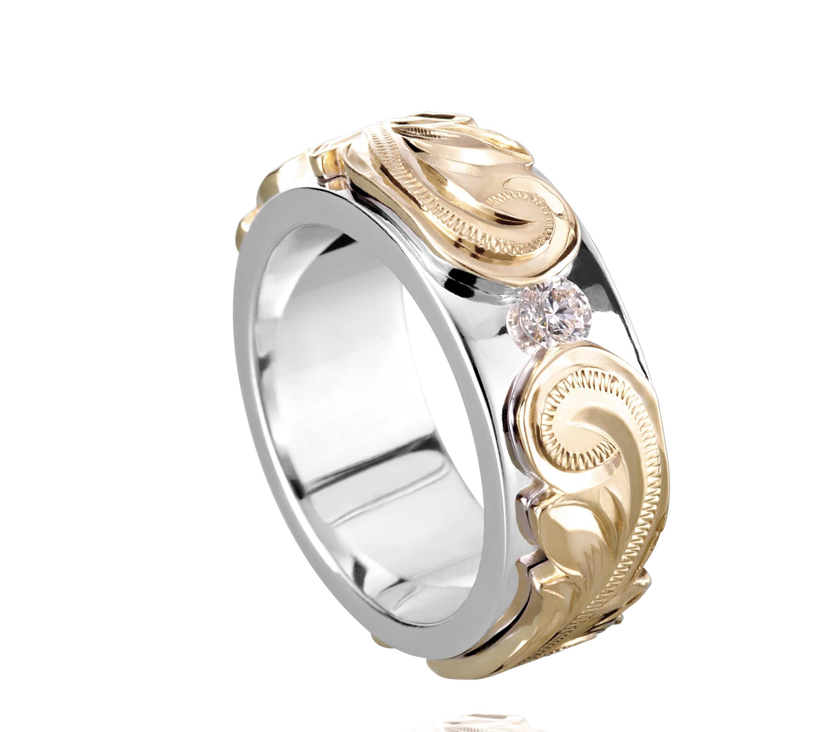 The picture shows a 14K white and yellow gold two-tone pinched 8 mm ring with hand-engravings and a diamond.