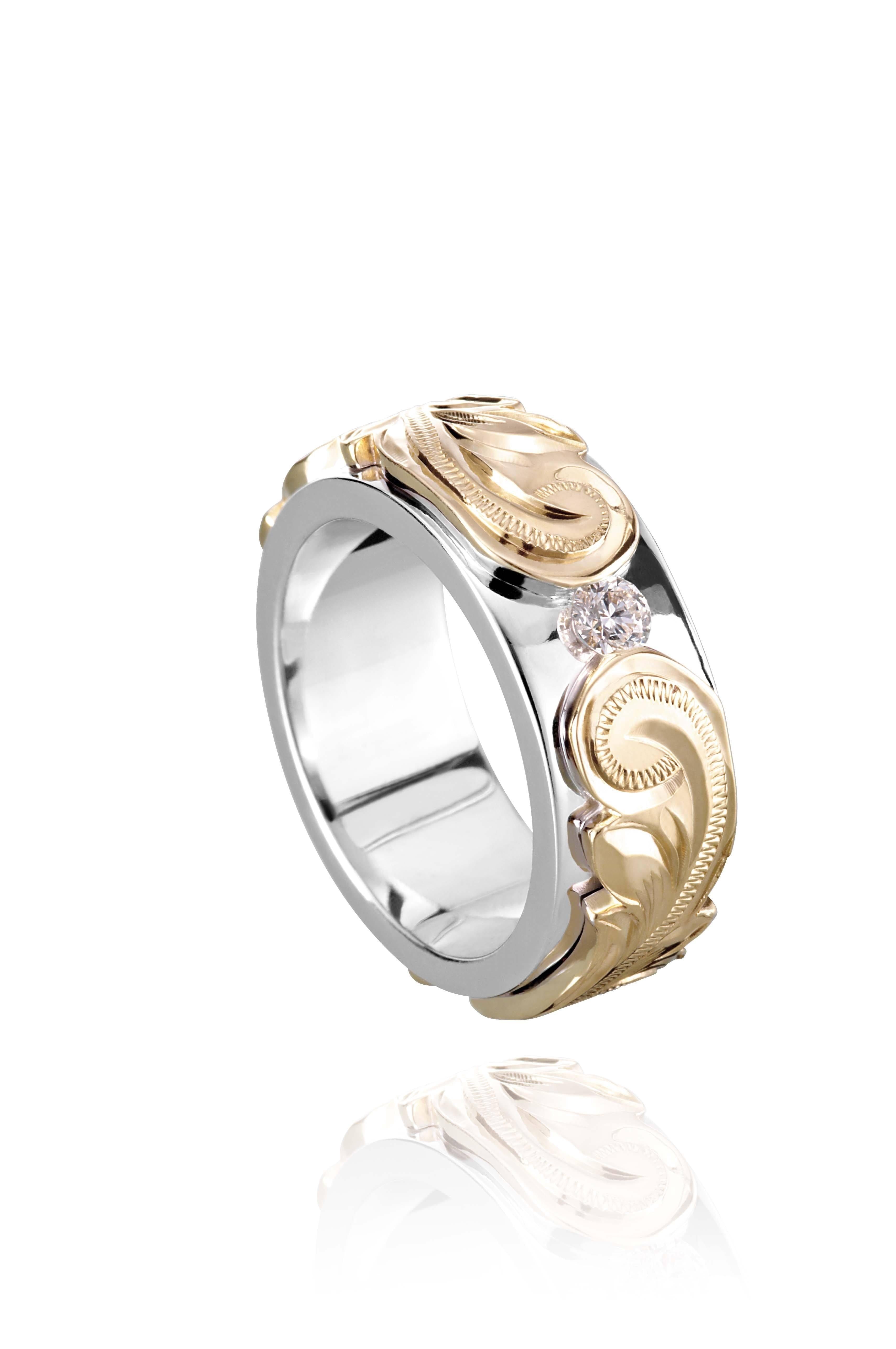 The picture shows a 14K white and yellow gold two-tone pinched 8 mm ring with hand-engravings and a diamond.