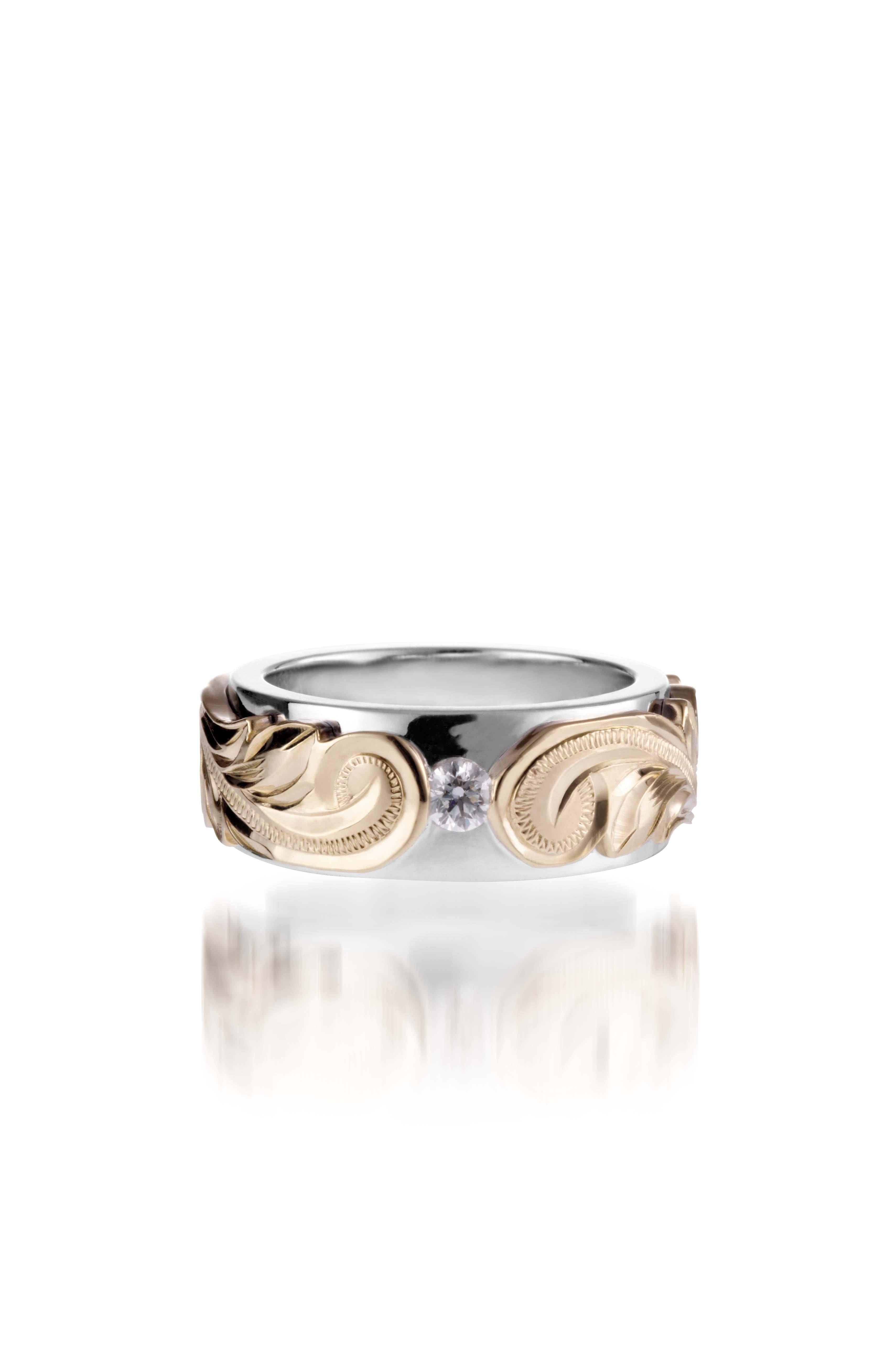 The picture shows a 14K white and yellow gold two-tone pinched 8 mm ring with hand-engravings and a diamond.