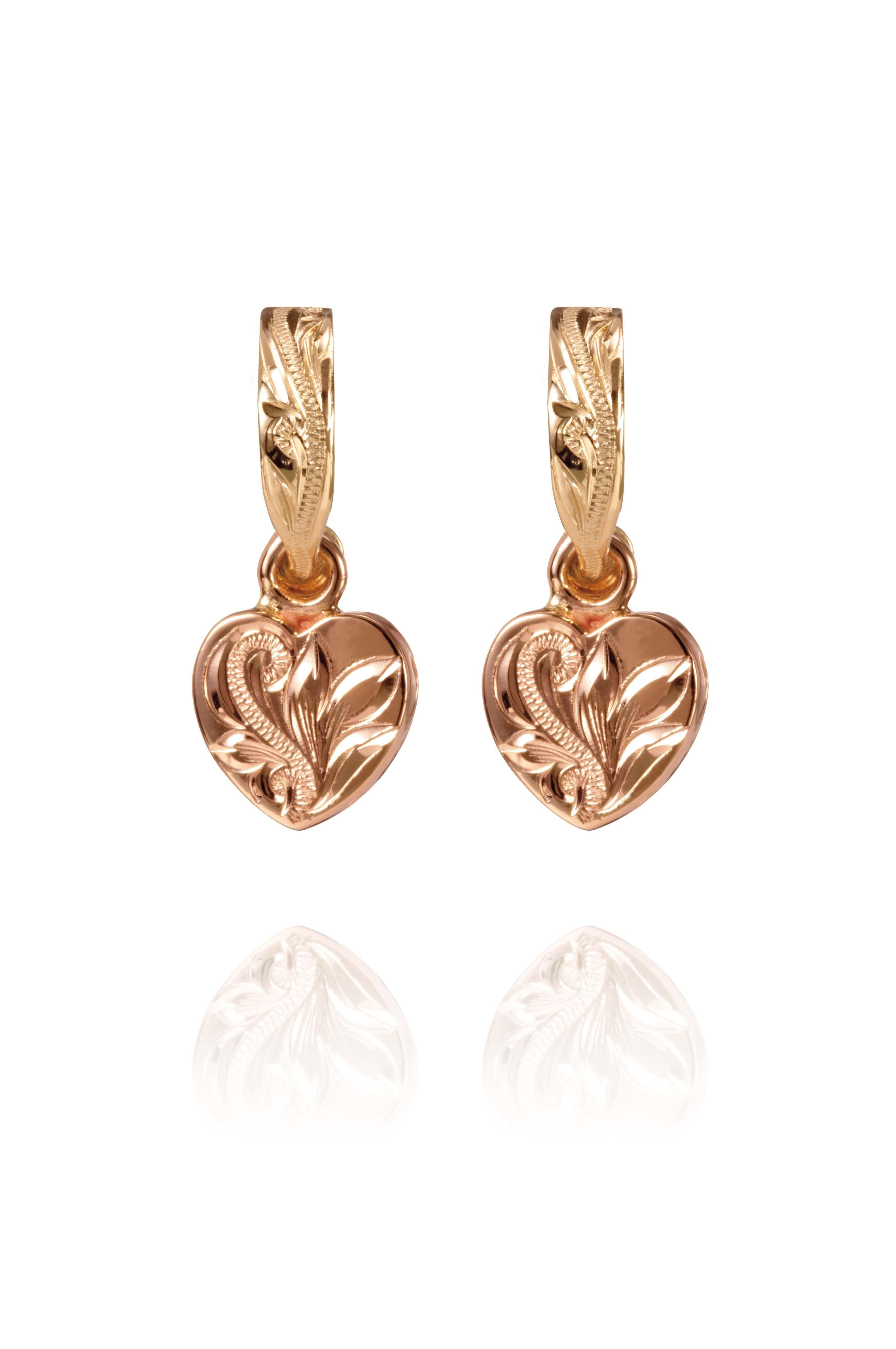 The picture shows a pair of 14K yellow and rose gold two-tone heart earrings with scroll engraving.