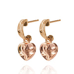 The picture shows a pair of 14K yellow and rose gold two-tone heart earrings with scroll engraving.