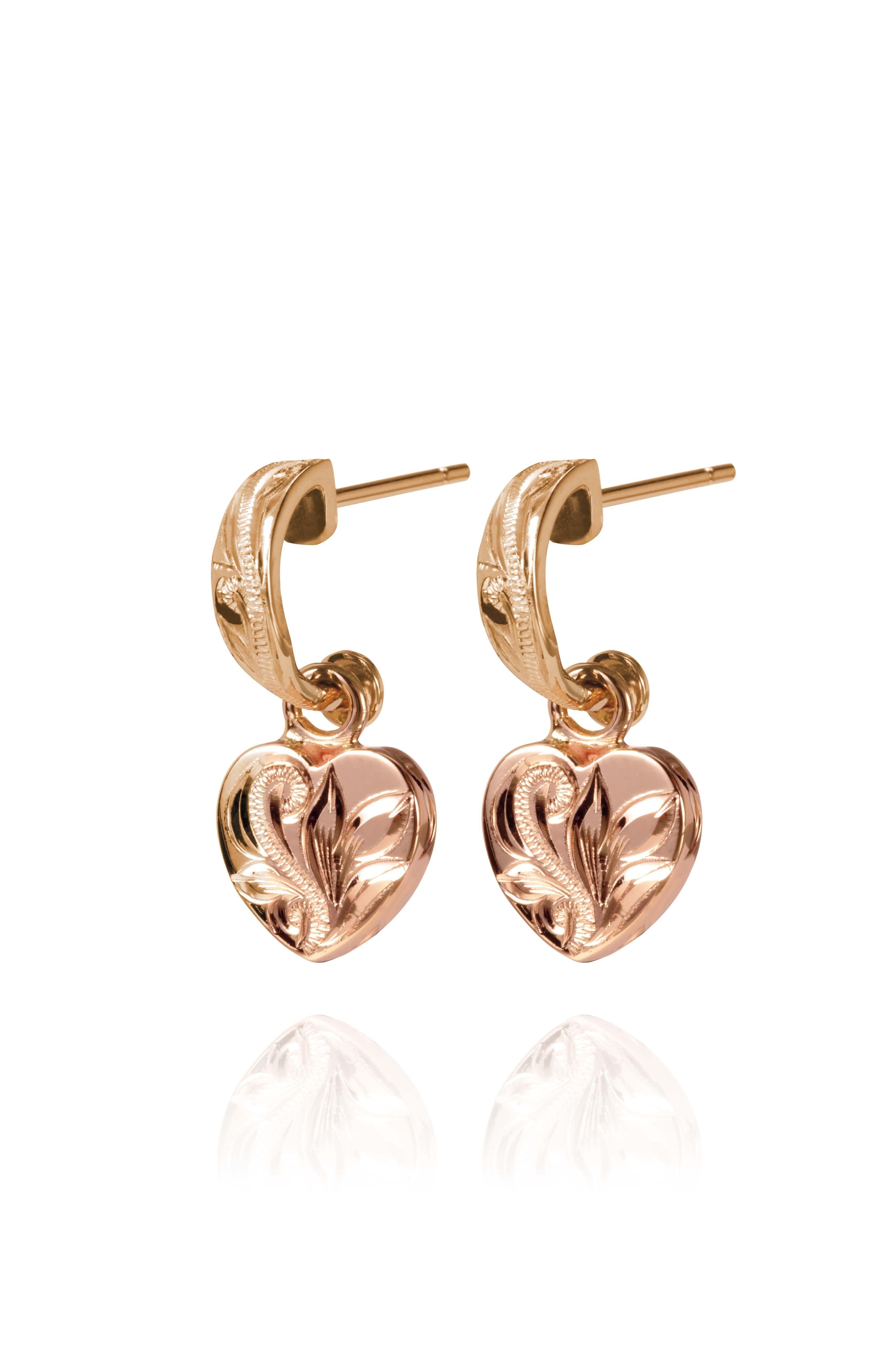 The picture shows a pair of 14K yellow and rose gold two-tone heart earrings with scroll engraving.