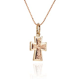 The picture shows a 14K yellow and rose gold two-tone cross pendant with hand engravings.