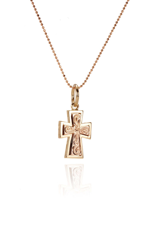 The picture shows a 14K yellow and rose gold two-tone cross pendant with hand engravings.