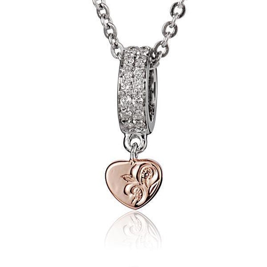 The picture shows a 14K white and rose gold two-tone pendant with hand engravings and diamonds.