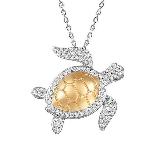 The picture shows a 14K white and yellow gold sea turtle pendant with pavé diamonds.