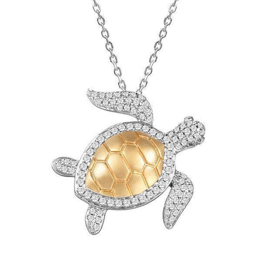 The picture shows a 14K white and yellow gold sea turtle pendant with pavé diamonds.