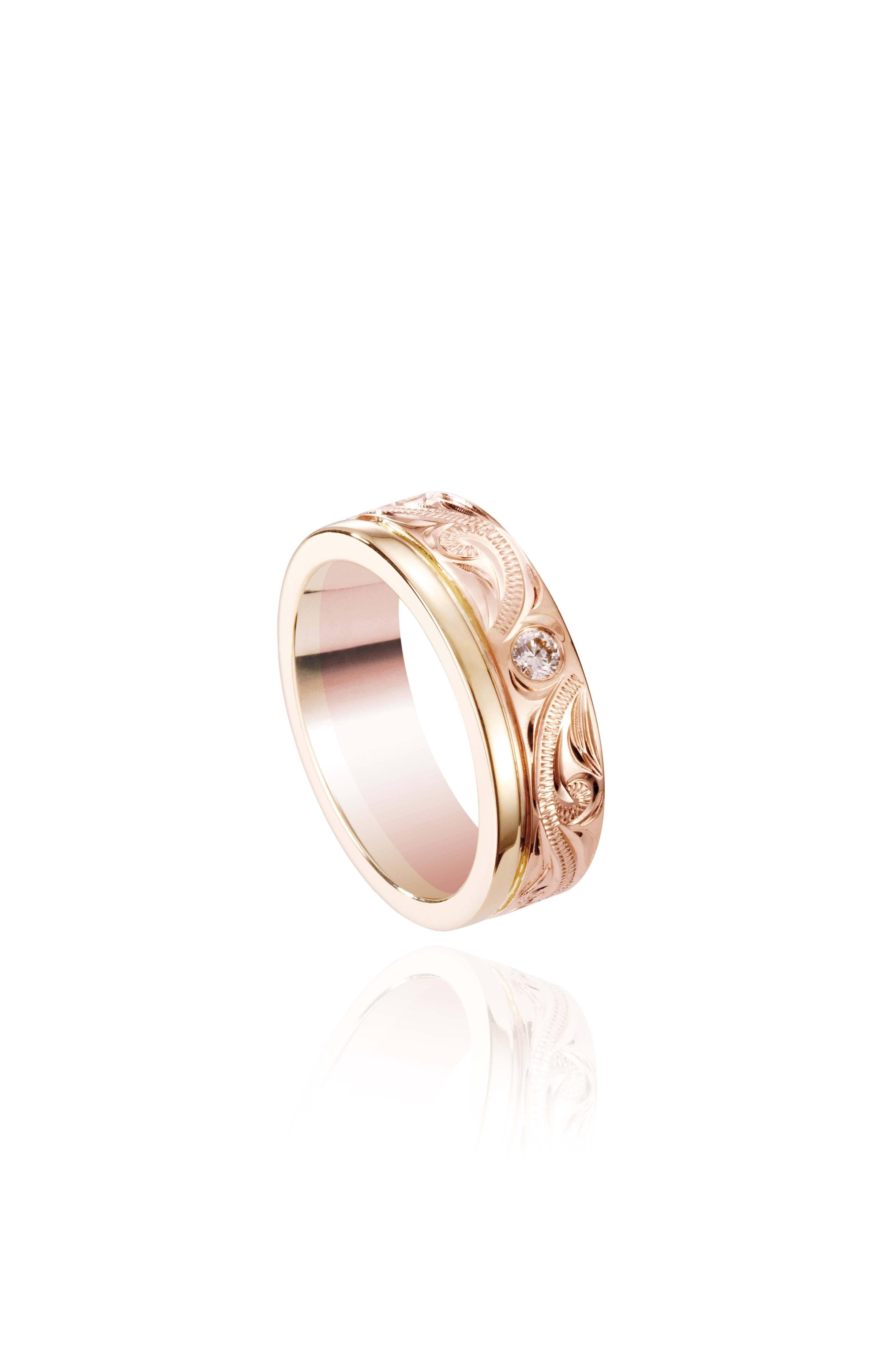 The picture shows a 14K yellow and rose gold two-tone wave channel 6mm ring with a diamond and hand-engravings.
