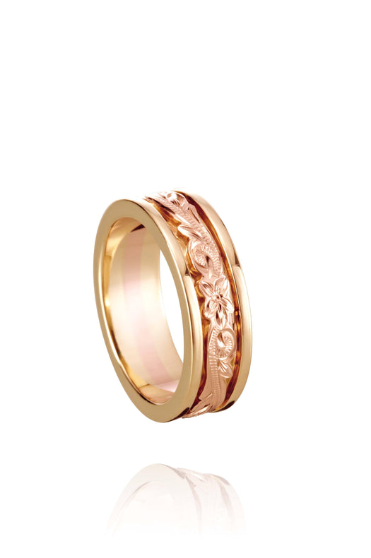 In this photo there is a yellow and rose gold two-tone ring with flower and scroll hand-engravings.