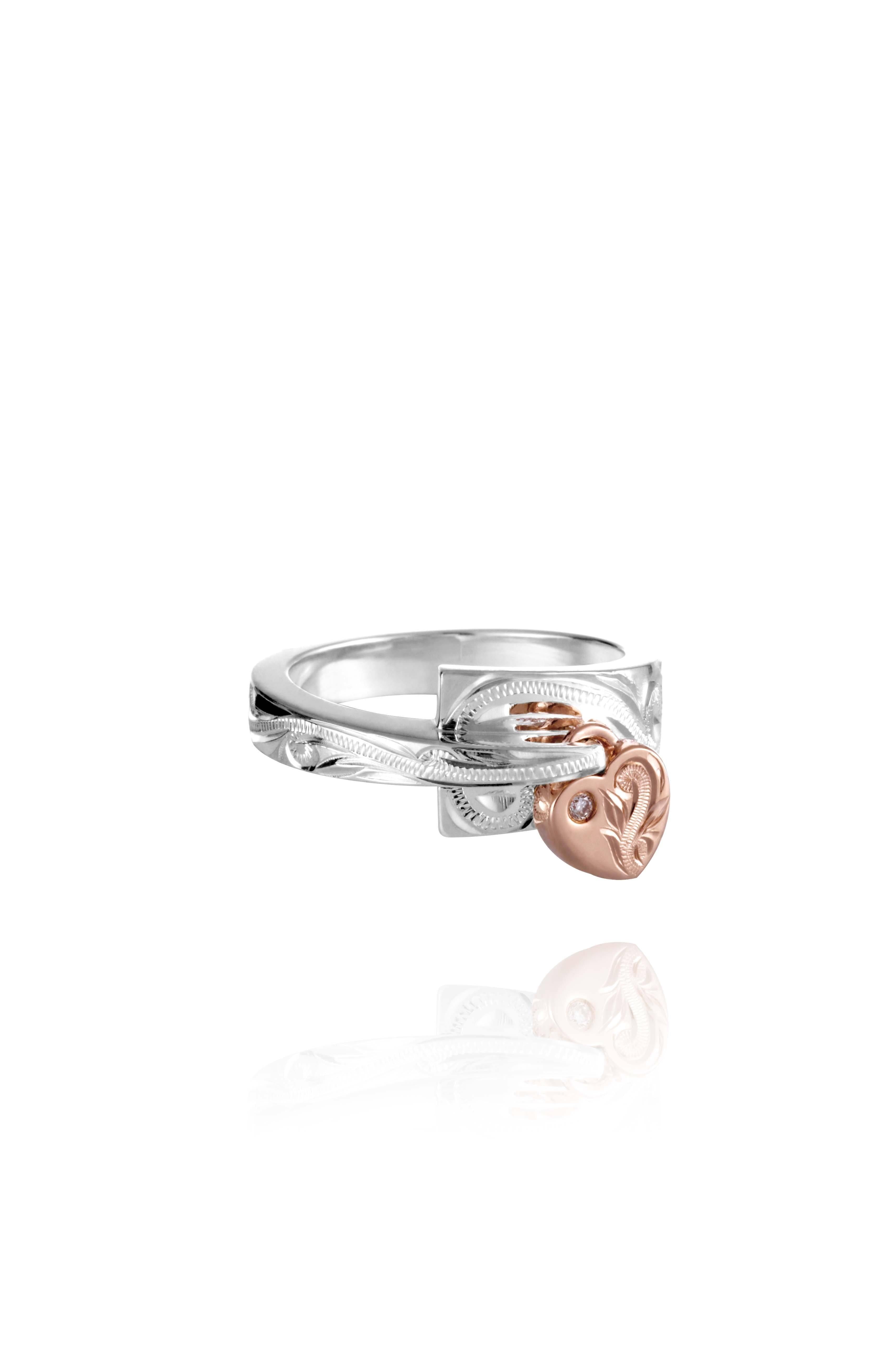 The picture shows a 14K rose gold and 925 sterling silver two-tone heart wrap ring with hand-engravings and a diamond.