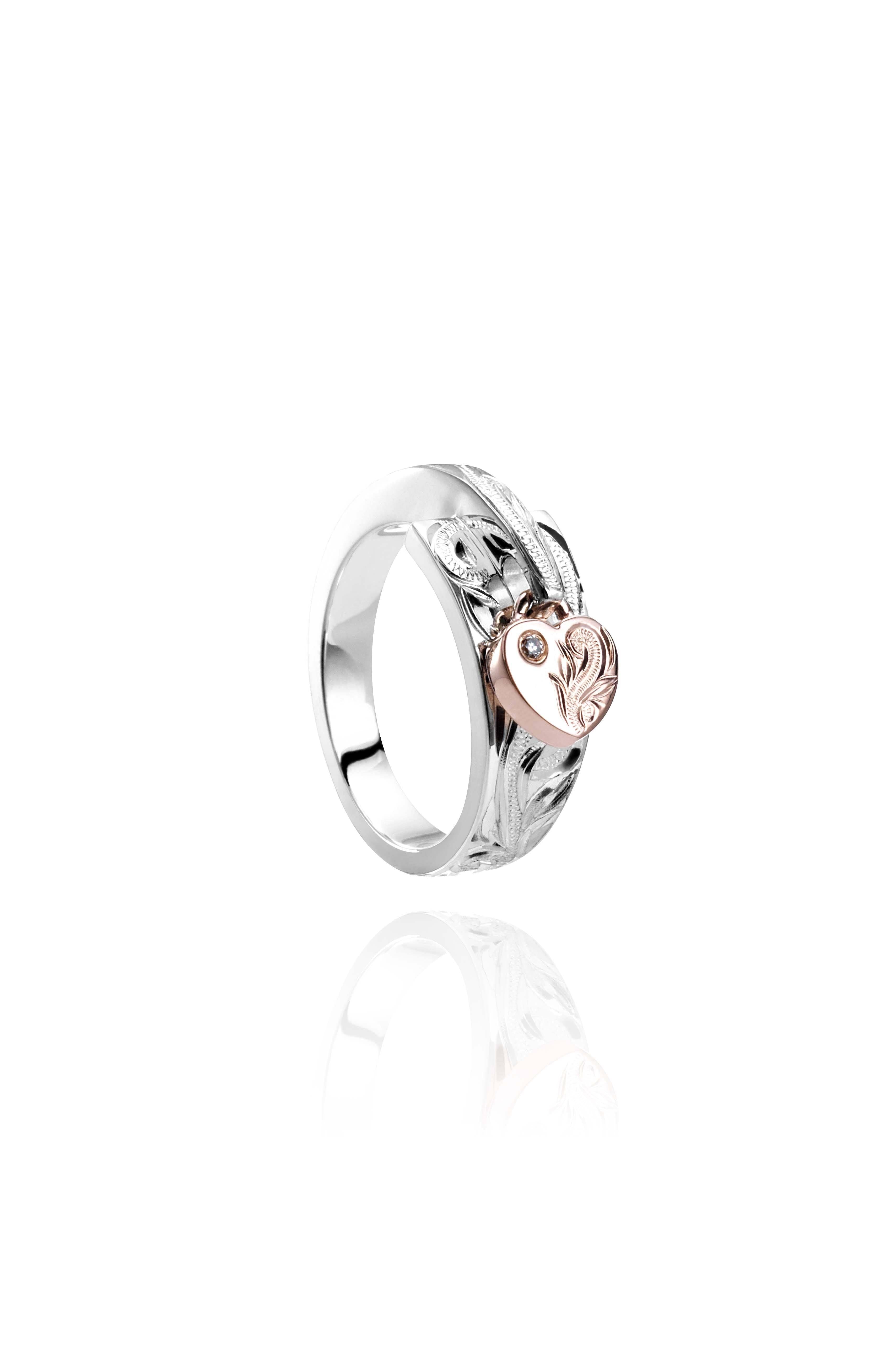 The picture shows a 14K rose gold and 925 sterling silver two-tone heart wrap ring with hand-engravings and a diamond.
