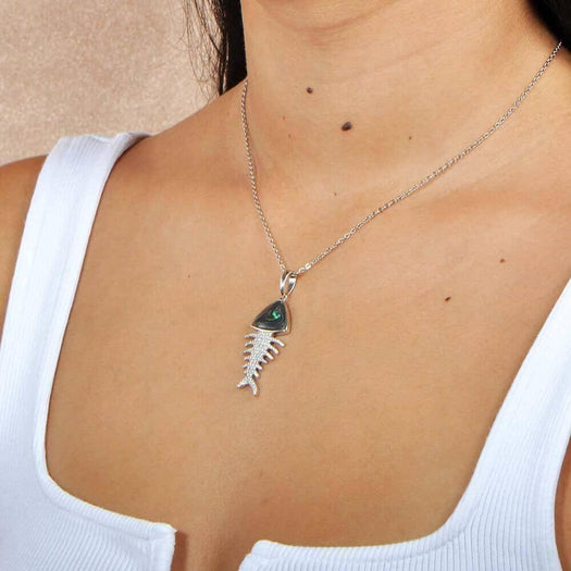 Sterling silver Fishbone Pendant featuring abalone, and white topaz, worn by a model. 