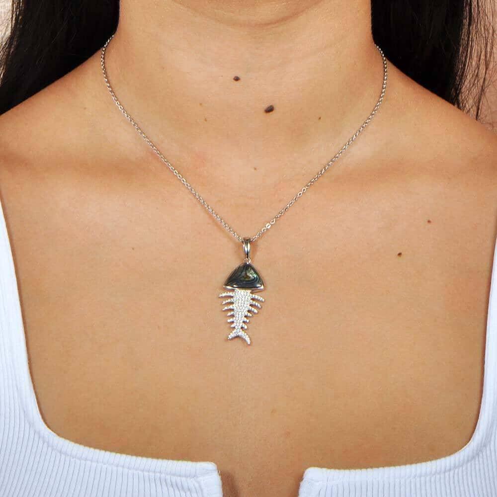 Sterling silver Fishbone Pendant featuring abalone, and white topaz, worn by a model. 