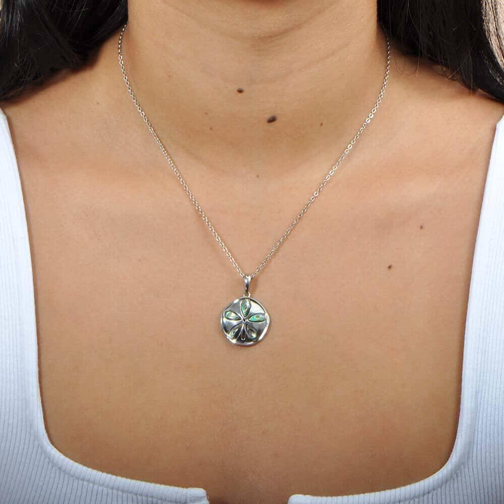 Sterling silver sand dollar pendant with abalone, worn by a model. 
