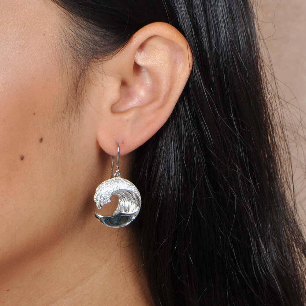 Sterling silver Ocean Wave Earrings featuring white topaz and Abalone worn by a model