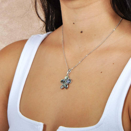Sterling silver plumeria pendant featuring Abalone pedals, worn by a model.