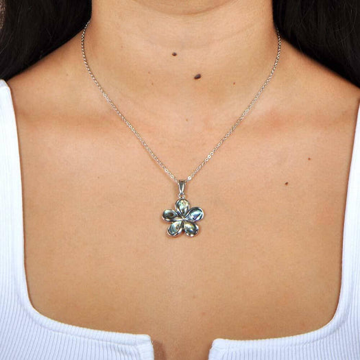 A model wearing a Sterling silver plumeria pendant featuring Abalone pedals.
