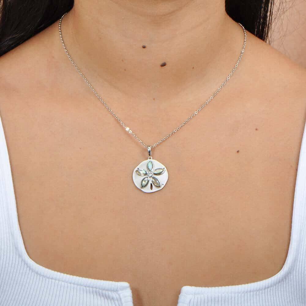 Sterling silver and Abalone Sand dollar pendant. The pendant is worn by a model.