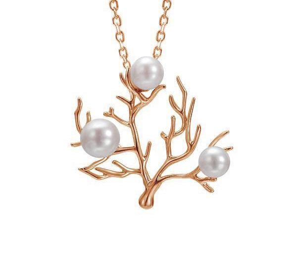 In this photo there is a large rose gold coral pendant with three white pearls.