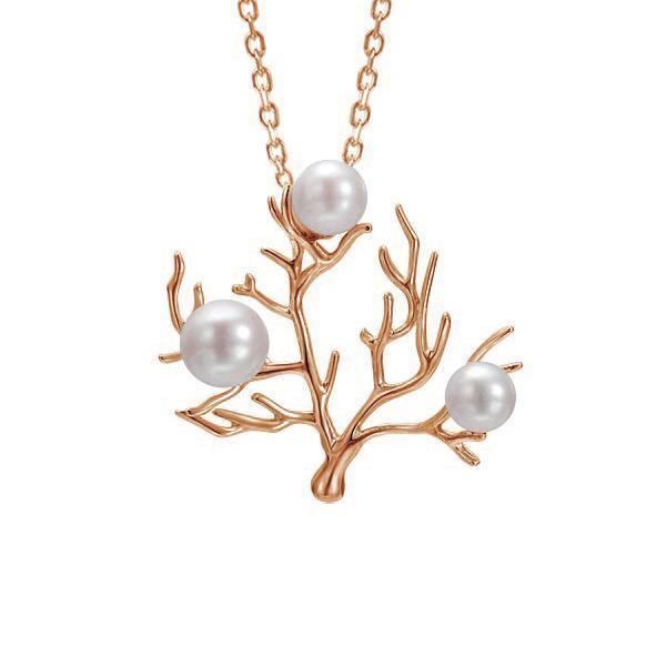 In this photo there is a large rose gold coral pendant with three white pearls.