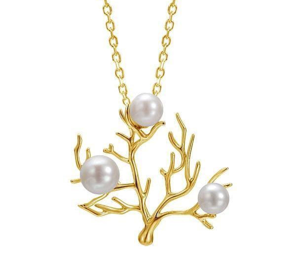 In this photo there is a small 14K yellow gold coral pendant with three white pearls.