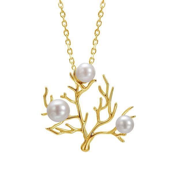 In this photo there is a small 14K yellow gold coral pendant with three white pearls.