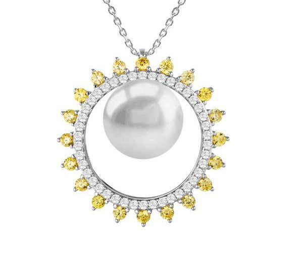 In this photo there is a white gold sun circle pendant with a white Akoya pearl and white and yellow diamonds.