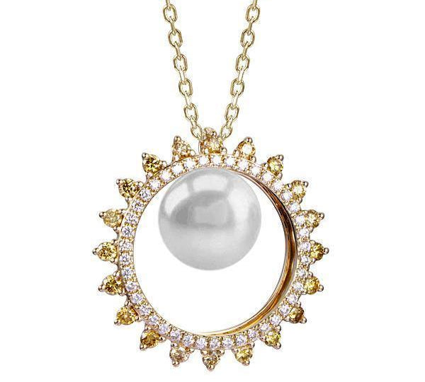 In this photo there is a yellow gold sun circle pendant with a white Akoya pearl and white and yellow diamonds.