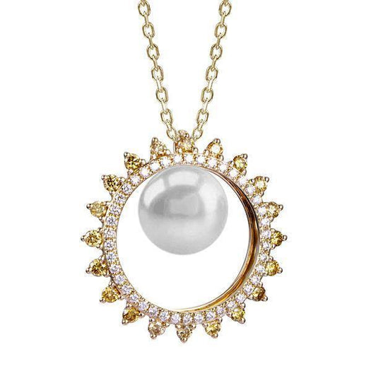 In this photo there is a yellow gold sun circle pendant with a white Akoya pearl and white and yellow diamonds.
