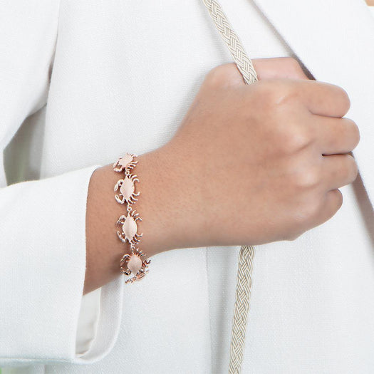 The picture shows a model wearing a  925 sterling silver rose gold-plated blue crab bracelet.
