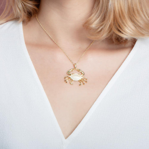 The picture shows a 925 sterling silver, yellow gold vermeil crab pendant.